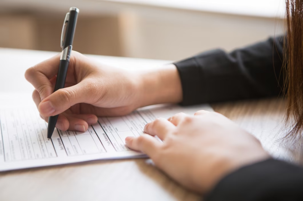 woman filing papers for buying a car